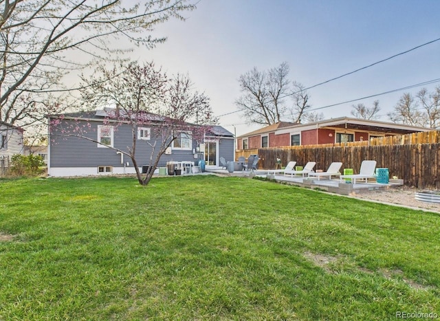 back of house with a yard, a patio area, and fence