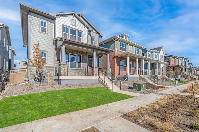 view of front of house featuring central AC unit, a porch, and a front yard