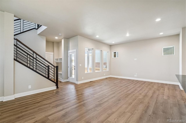 unfurnished living room featuring light hardwood / wood-style floors