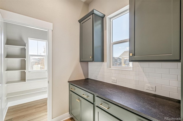 kitchen featuring tasteful backsplash and light hardwood / wood-style flooring