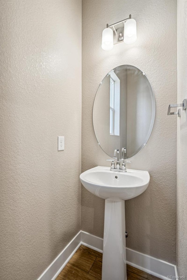 bathroom with hardwood / wood-style floors