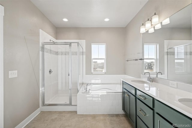 bathroom featuring vanity, a healthy amount of sunlight, and shower with separate bathtub