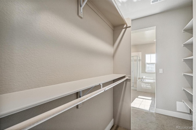 spacious closet with light tile patterned flooring