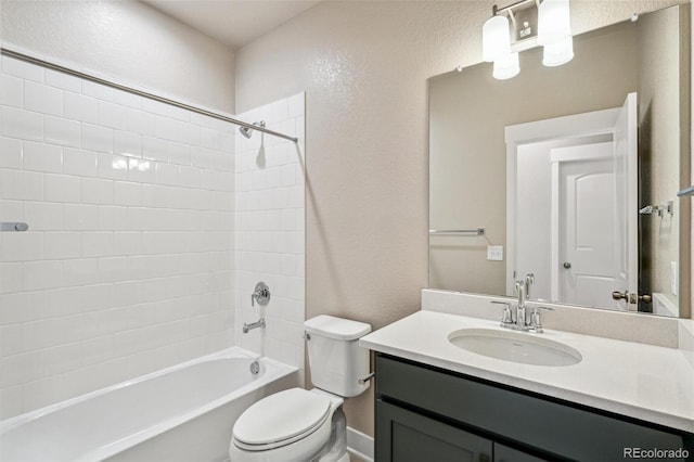 full bathroom featuring vanity, toilet, and tiled shower / bath