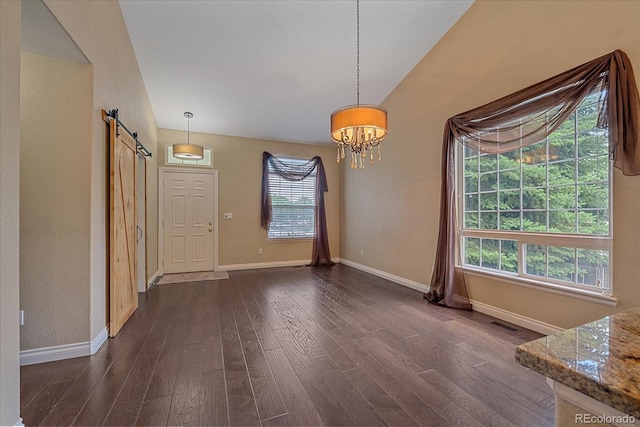 9406 Troon Village Way, Lone Tree, CO 80124 - unfurnished dining area featuring a barn door, a chandelier, and dark wood finished floors