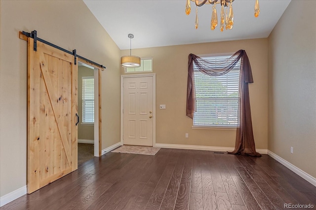 9406 Troon Village Way, Lone Tree, CO 80124 - foyer entrance with a barn door, dark wood finished floors, a chandelier, healthy amount of natural light, and vaulted ceiling