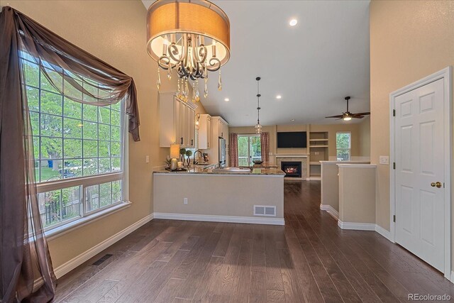 9406 Troon Village Way, Lone Tree, CO 80124 - kitchen featuring healthy amount of natural light, ceiling fan, dark wood finished floors, a glass covered fireplace, and recessed lighting