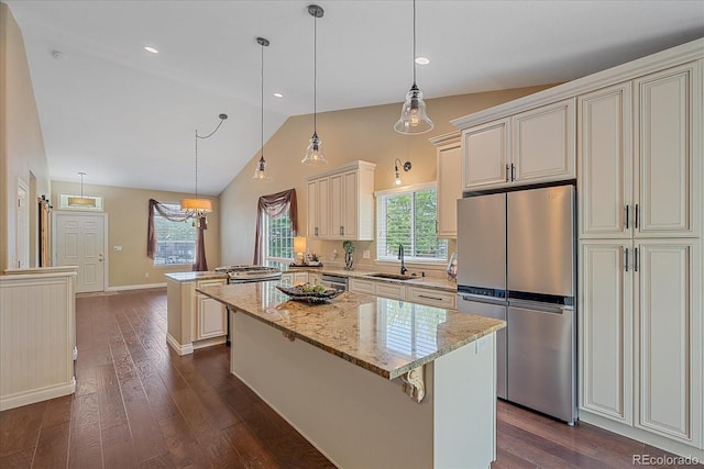 9406 Troon Village Way, Lone Tree, CO 80124 - kitchen featuring freestanding refrigerator, vaulted ceiling, dark wood-style flooring, a peninsula, and a center island