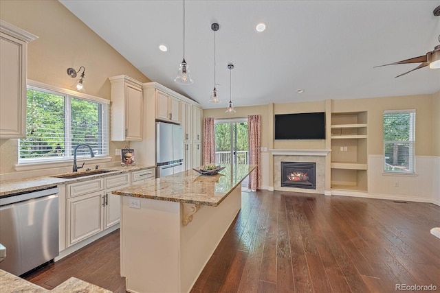9406 Troon Village Way, Lone Tree, CO 80124 - kitchen featuring dishwasher, fridge, open floor plan, light stone counters, and a glass covered fireplace