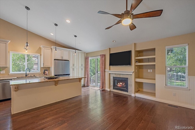 9406 Troon Village Way, Lone Tree, CO 80124 - kitchen with stainless steel appliances, dark wood finished floors, a kitchen island, a ceiling fan, and lofted ceiling