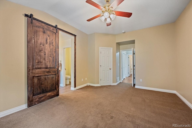 9406 Troon Village Way, Lone Tree, CO 80124 - unfurnished bedroom featuring carpet, a barn door, connected bathroom, and ceiling fan