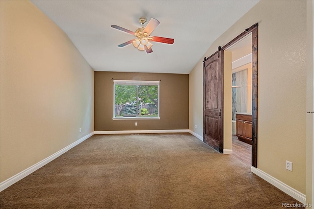 9406 Troon Village Way, Lone Tree, CO 80124 - empty room with ceiling fan, carpet, a barn door, and vaulted ceiling