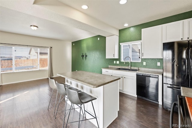 kitchen with dishwasher, dark wood-style flooring, refrigerator, white cabinetry, and a sink