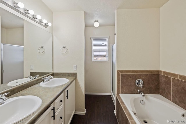 full bath featuring double vanity, a sink, and a bath