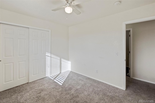 unfurnished bedroom with carpet, a closet, ceiling fan, and baseboards