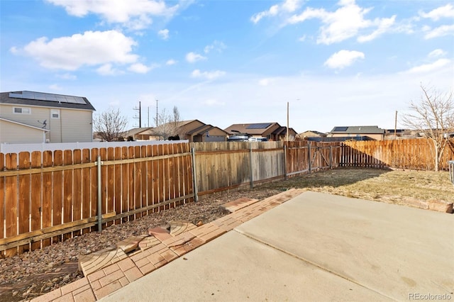 view of patio / terrace featuring a fenced backyard and a residential view