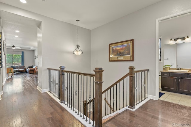 21376 E Union Pl, Aurora, CO 80015 - hallway with a sink, light wood-type flooring, an upstairs landing, recessed lighting, and baseboards