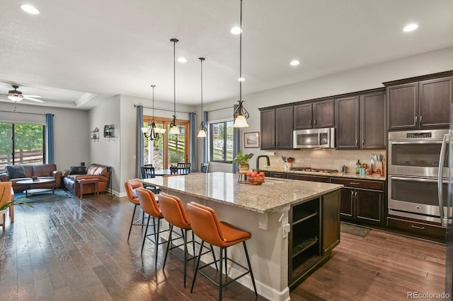 21376 E Union Pl, Aurora, CO 80015 - kitchen featuring stainless steel appliances, recessed lighting, dark brown cabinetry, and dark wood finished floors