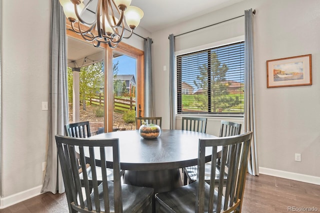 21376 E Union Pl, Aurora, CO 80015 - dining area featuring a chandelier, dark wood-style flooring, and baseboards