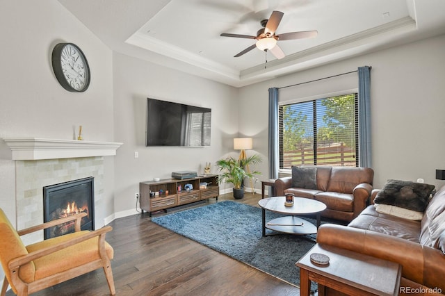 21376 E Union Pl, Aurora, CO 80015 - living room with a tray ceiling, wood finished floors, ceiling fan, a fireplace, and crown molding