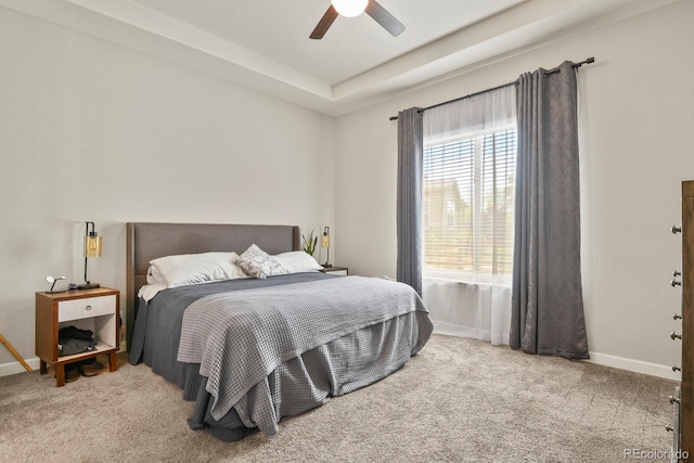 21376 E Union Pl, Aurora, CO 80015 - bedroom featuring carpet floors, baseboards, a tray ceiling, and a ceiling fan