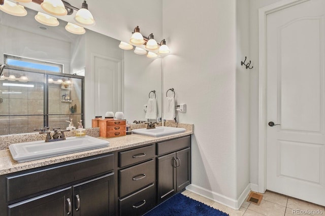 21376 E Union Pl, Aurora, CO 80015 - full bath featuring a shower stall, tile patterned flooring, double vanity, and baseboards