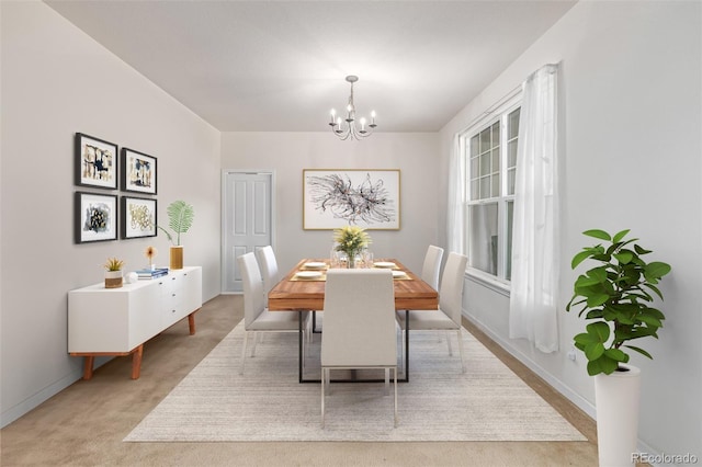 dining area with a chandelier and light carpet