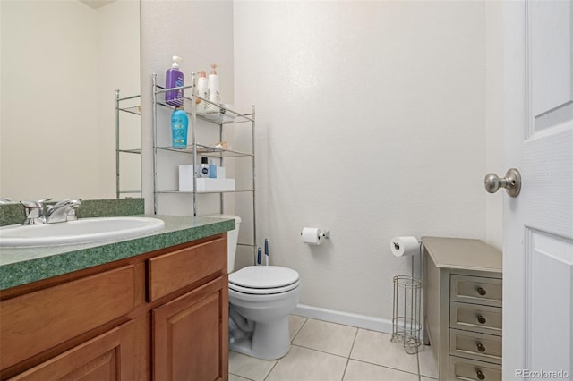 bathroom featuring tile patterned flooring, vanity, and toilet