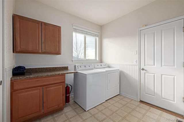 laundry room featuring washer and dryer and cabinets