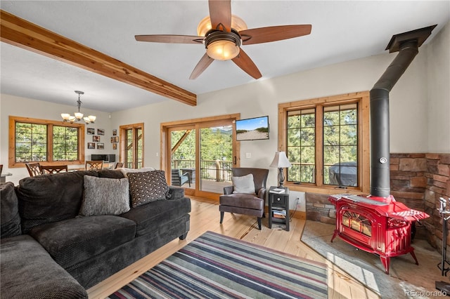 715 Clark Rd, Bailey, CO 80421 - living area with a wood stove, a chandelier, plenty of natural light, and beam ceiling
