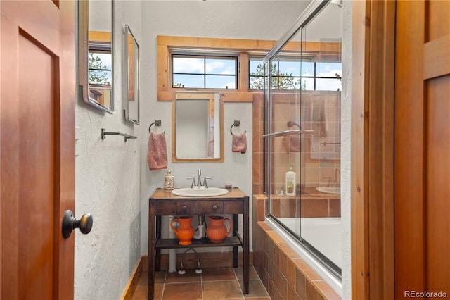 715 Clark Rd, Bailey, CO 80421 - bathroom with healthy amount of natural light, vanity, tile patterned flooring, and tiled shower / bath