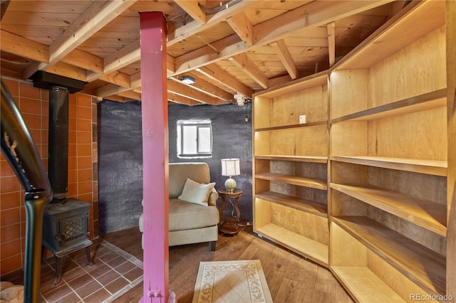 715 Clark Rd, Bailey, CO 80421 - sitting room featuring hardwood / wood-style flooring, a wood stove, and a wooden ceiling with exposed beams