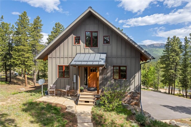 715 Clark Rd, Bailey, CO 80421 - view of front of property with board and batten siding and a mountain view