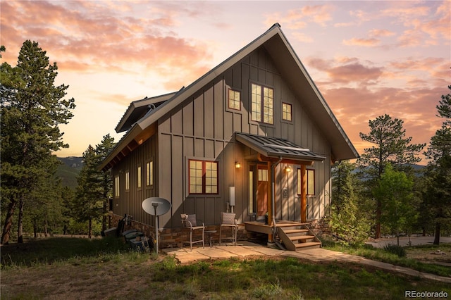 715 Clark Rd, Bailey, CO 80421 - view of front of home featuring board and batten siding, a standing seam roof, and a patio