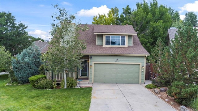 view of front of property with a garage and a front yard