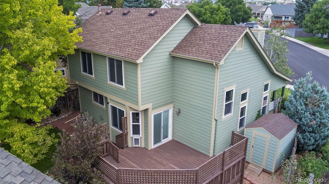 exterior space featuring a storage shed and a deck