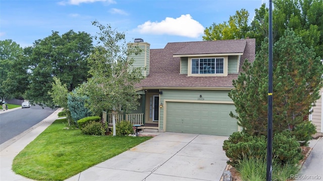 view of front of house featuring a garage and a front yard