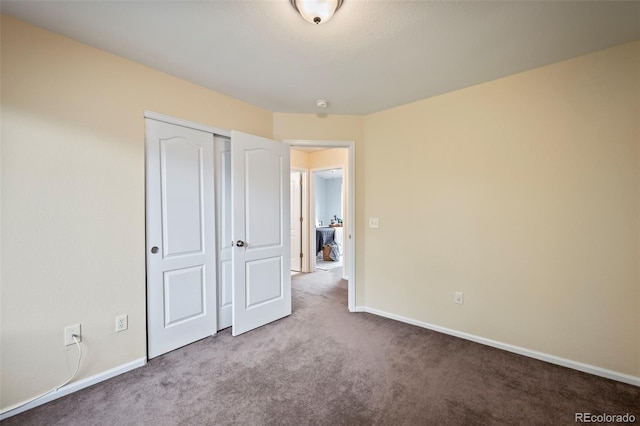 unfurnished bedroom with light carpet and a closet