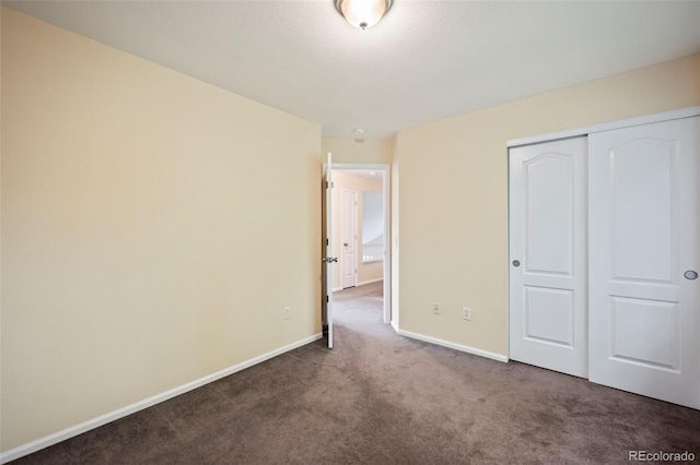 unfurnished bedroom with a closet and carpet