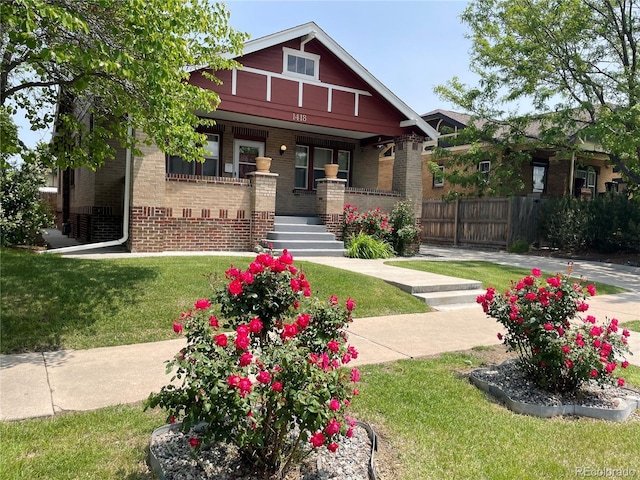 craftsman-style house featuring a porch and brick siding