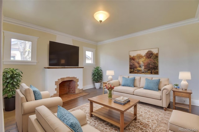 living area featuring crown molding, wood finished floors, a brick fireplace, and baseboards