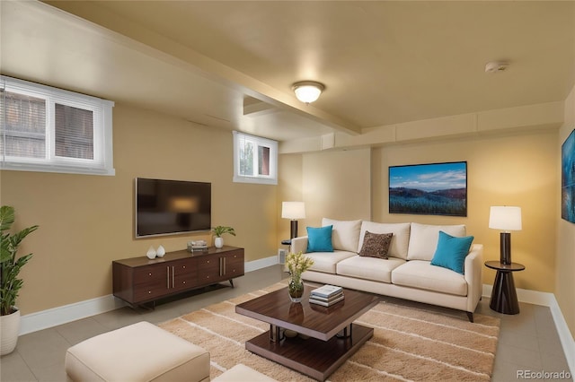 tiled living area with baseboards and beam ceiling