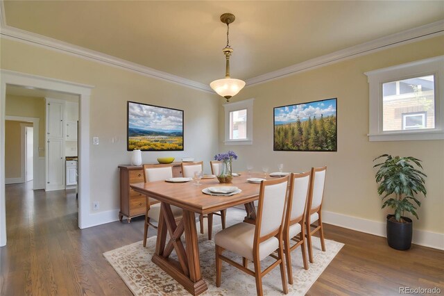 dining space featuring crown molding, baseboards, and dark wood-style flooring