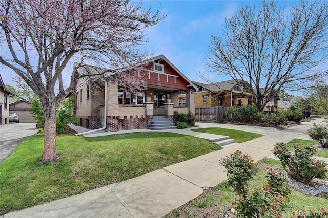view of front of property with brick siding, covered porch, and an outdoor structure
