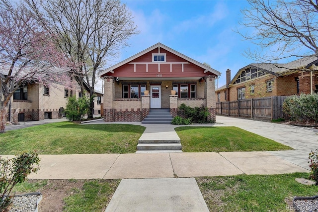 craftsman-style house featuring a porch and brick siding