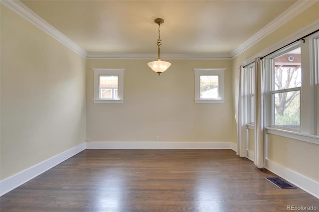 empty room featuring crown molding, baseboards, and dark wood-style flooring
