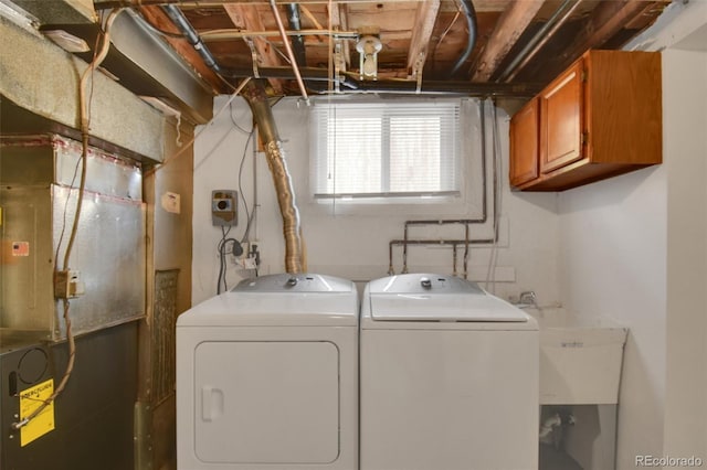 washroom with cabinet space and washing machine and dryer