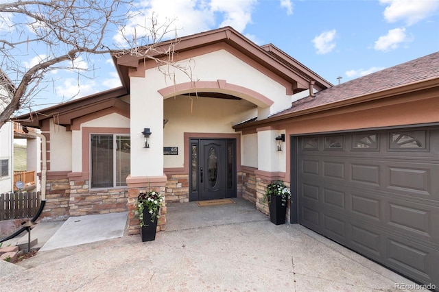 415 Butte Pkwy, Golden, CO 80403 - doorway to property featuring stone siding, stucco siding, driveway, and a garage