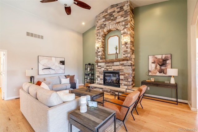 415 Butte Pkwy, Golden, CO 80403 - living room with high vaulted ceiling, ceiling fan, light wood finished floors, a fireplace, and baseboards