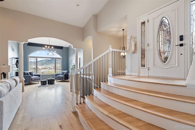 415 Butte Pkwy, Golden, CO 80403 - entryway with a chandelier, ornate columns, arched walkways, and wood finished floors
